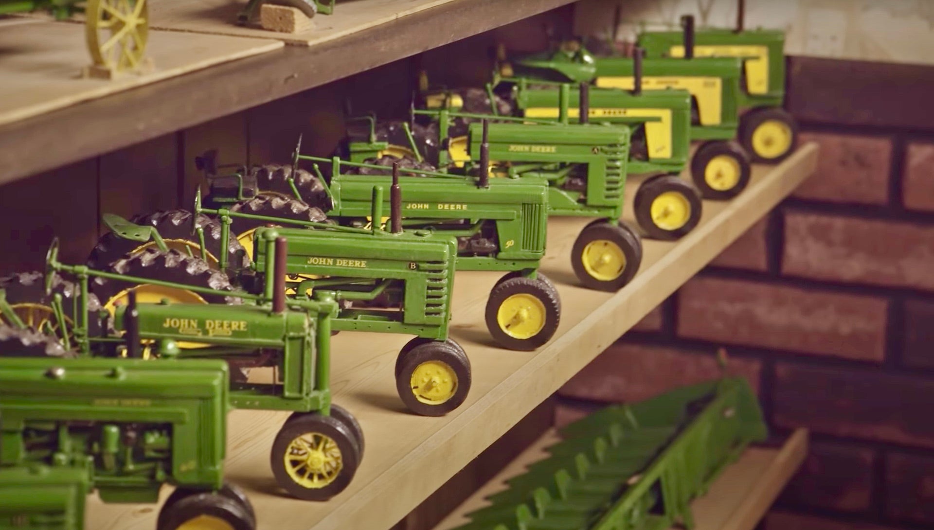 Painted wooden replicas of John Deere mowers