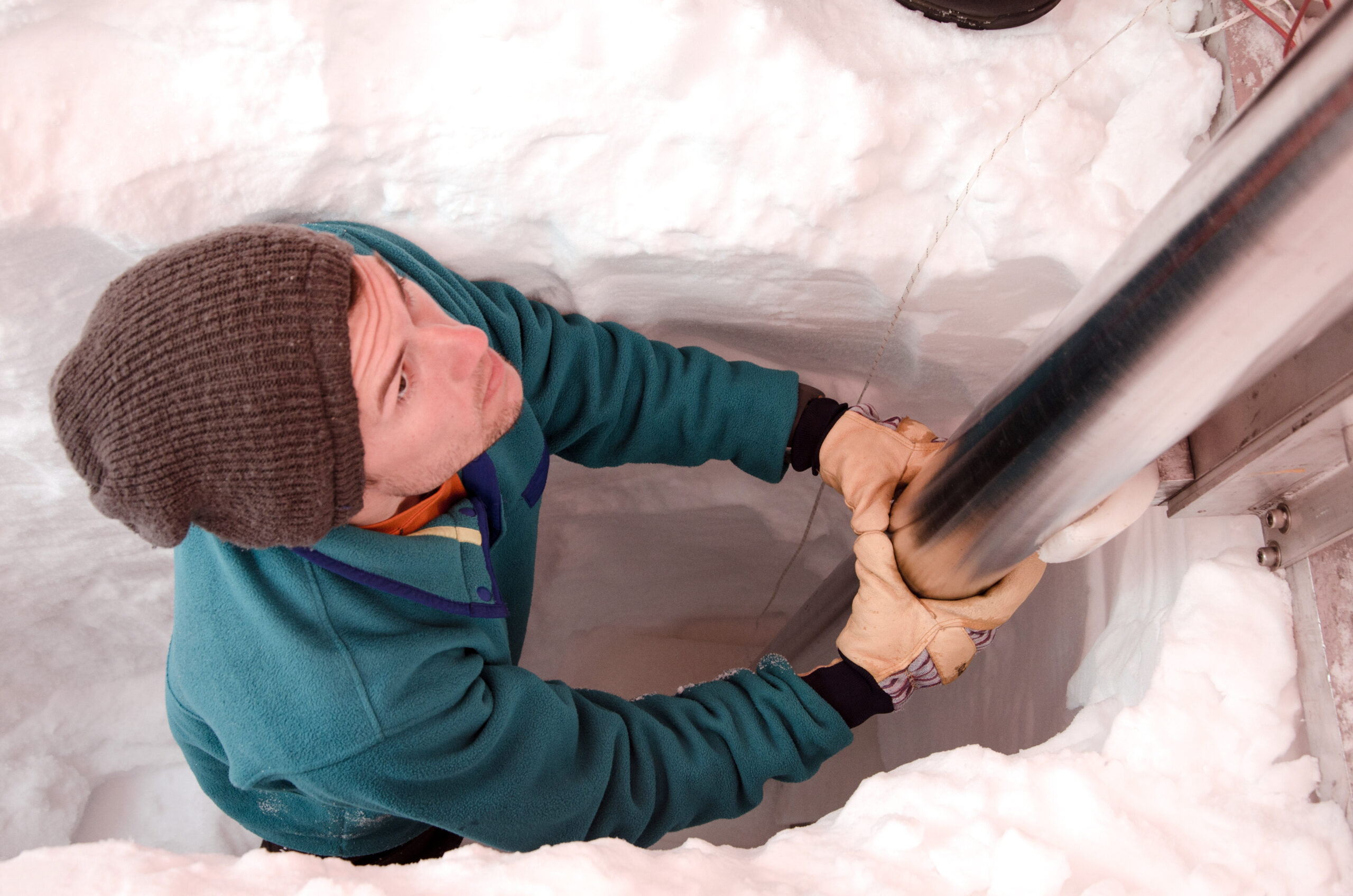 researcher drilling ice core