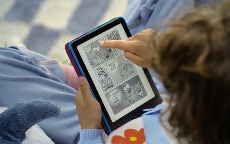 A child reading a graphic novel on an Amazon Kindle Paperwhite Kids.