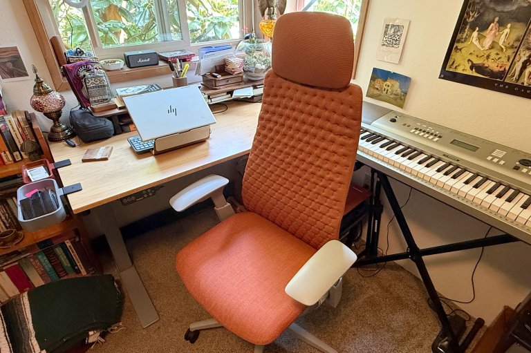 Terracotta-colored Haworth Fern splurge office chair sitting in a home office