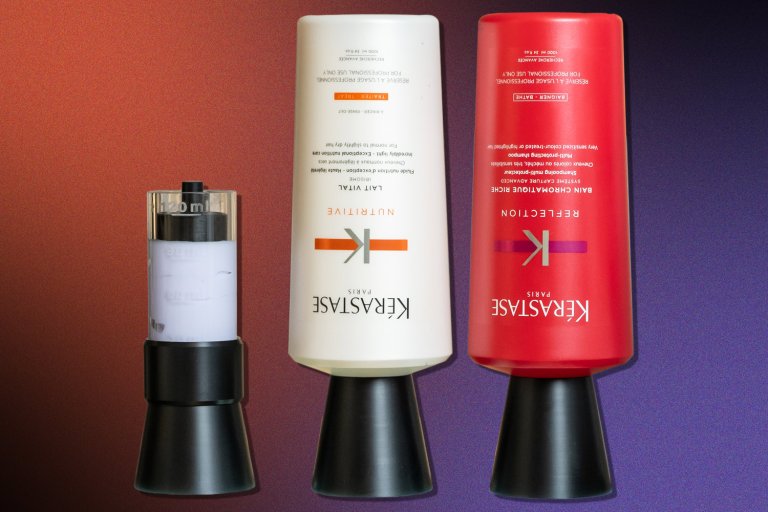 two bottles of hair product next to a black device