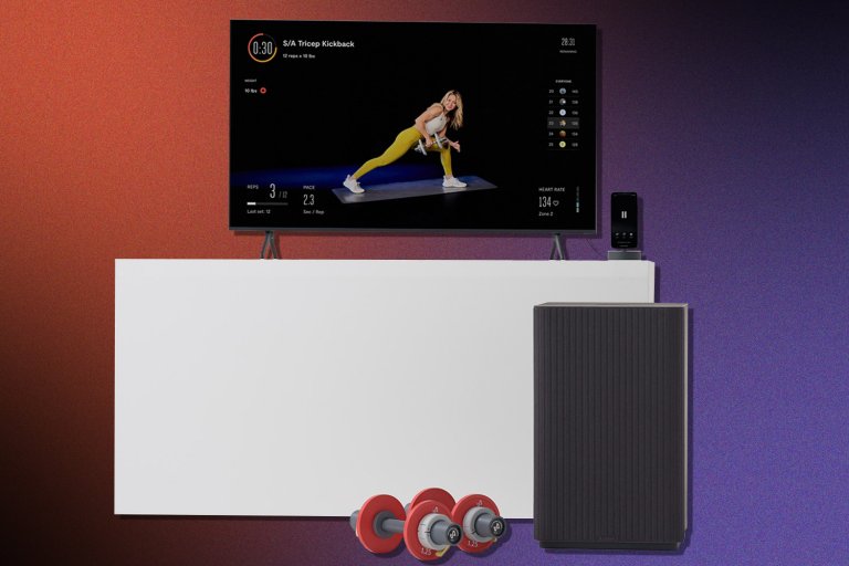 a TV displaying a woman in yellow tights lifting weights, next to a small cabinet that looks like an end table