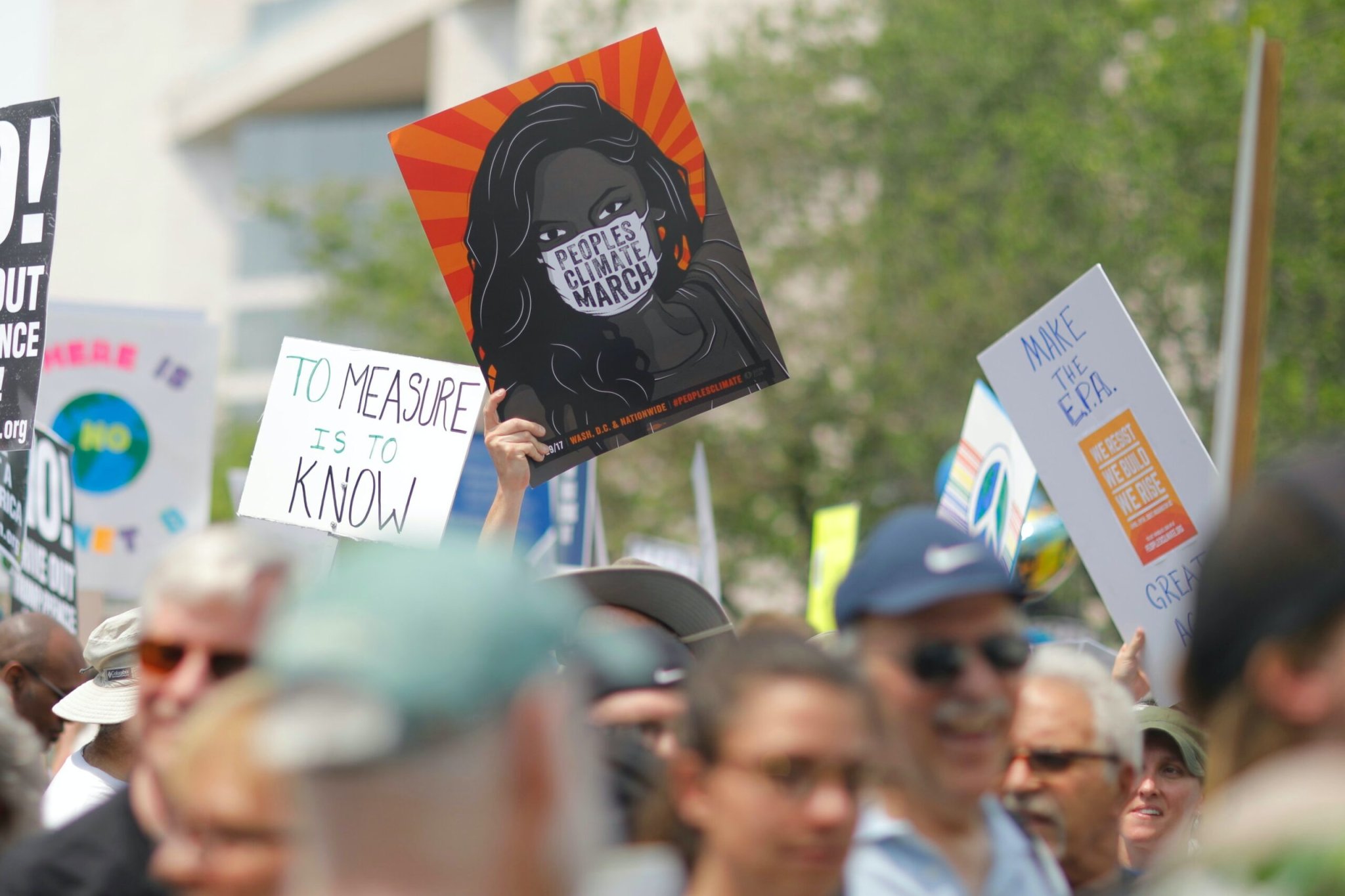 Climate change protest poster with COVID mask