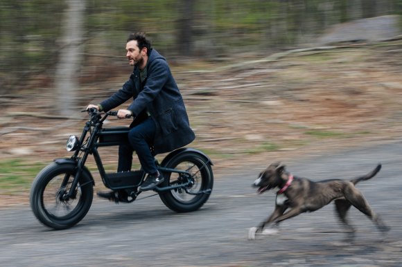 Ride1up Revv 1 bike ridden next to a running dog