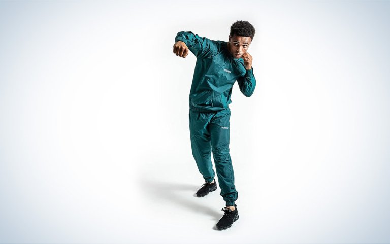 A man shadow boxes wearing the BOXRAW Hagler Professional Sauna Suit 1.0 against a white background