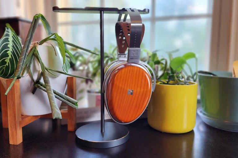 The HIFIMAN Audivina planar magnetic headphones on a stand in front of potted plants