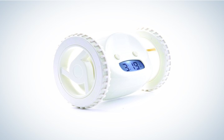  A white alarm clock with wheels on a blue and white background 