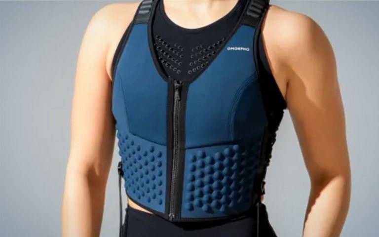 A woman wearing a blue weighted OMORPHO vest