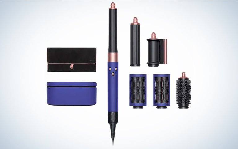 A rose and vinca blue Dyson AirWrap on a blue and white background