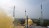 An ISRO rocket launches amid a brownish plume of exhaust.