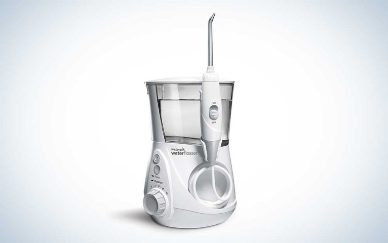 A Waterpik Aquarius water flosser on a plain background.