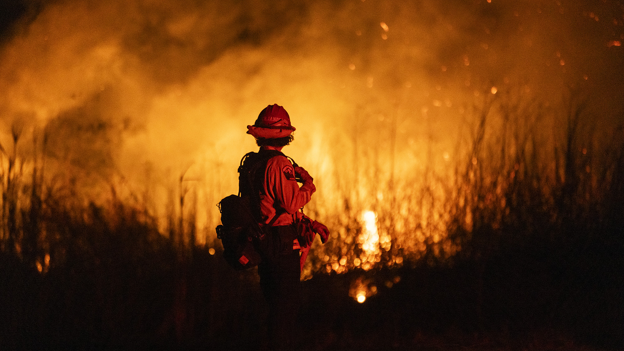 A firefighter monitors the spread of the Auto Fire in Oxnard, North West of Los Angeles, California, on January 13, 2025