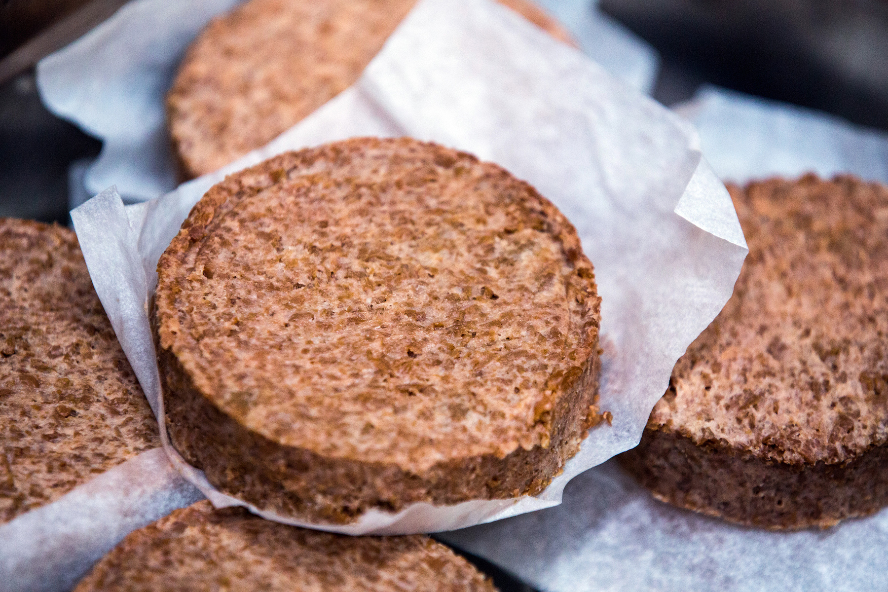 A group of uncooked meat free plant-based burger patties in a kitchen in Russia. 