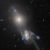 Elliptical galaxy NGC 3561B (upper left) and spiral galaxy NGC 3561A (lower right) form a shimmering guitar shape in the ongoing merger known collectively as Arp 105.
