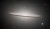 The Sombrero Galaxy is an oblong, pale white disc with a glowing core. It appears nearly edge-on but is slanted slightly in the front, presenting a slightly top-down view of the inner region of the galaxy and its bright core. The outer disc is darker with shades of brown and black. Different coloured distant galaxies and various stars are speckled among the black background of space surrounding the galaxy.