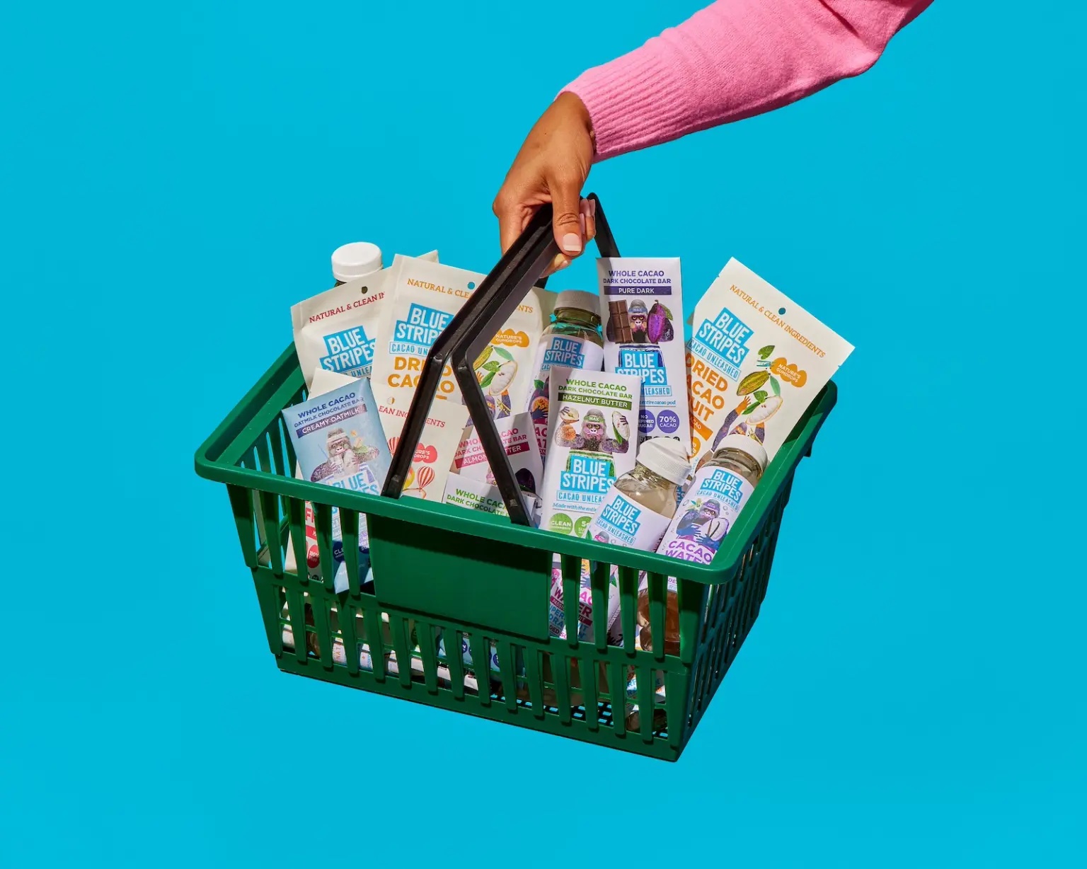 a hand holding a shopping back filled with blue stripes products