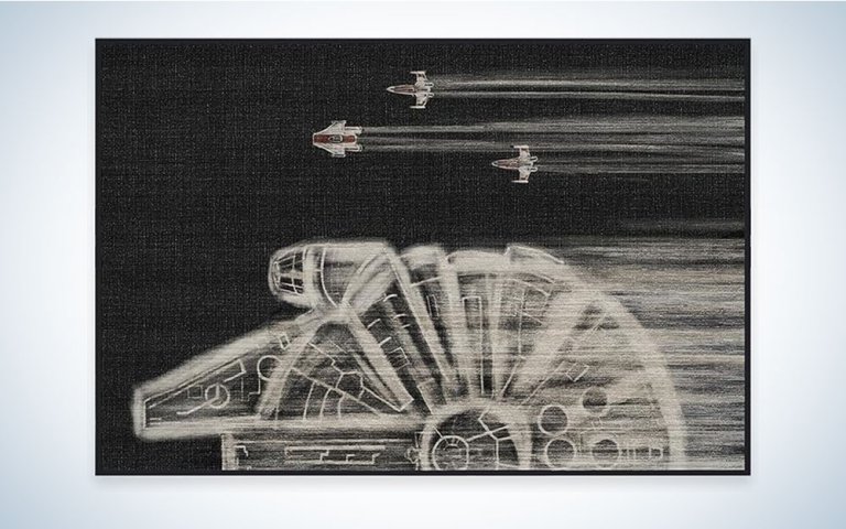 Ruggable Star Wars Rug with the Millennium Falcon and other ships on it.