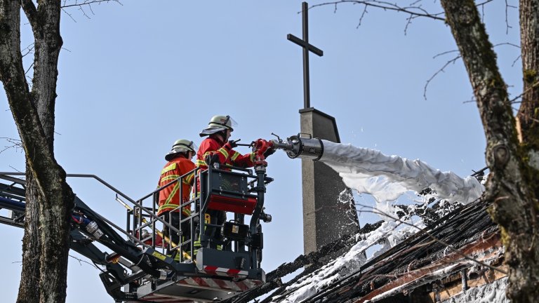 21 March 2022, Baden-Wuerttemberg, Singen Am Hohentwiel: After the overnight fire at the Peace Church downtown, the fire flared up again in one spot this morning. The fire department fights the small fire with extinguishing foam Photo: Felix Kästle/dpa (Photo by Felix Kästle/picture alliance via Getty Images)