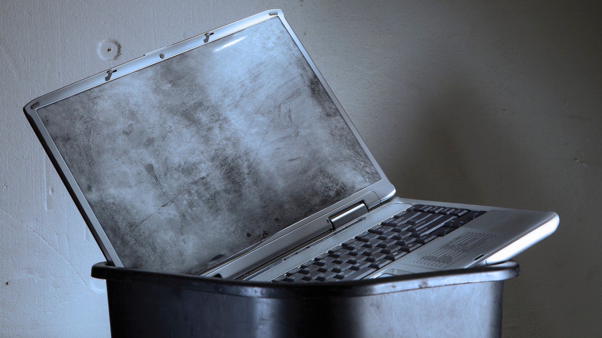 dirty laptop in garbage bin