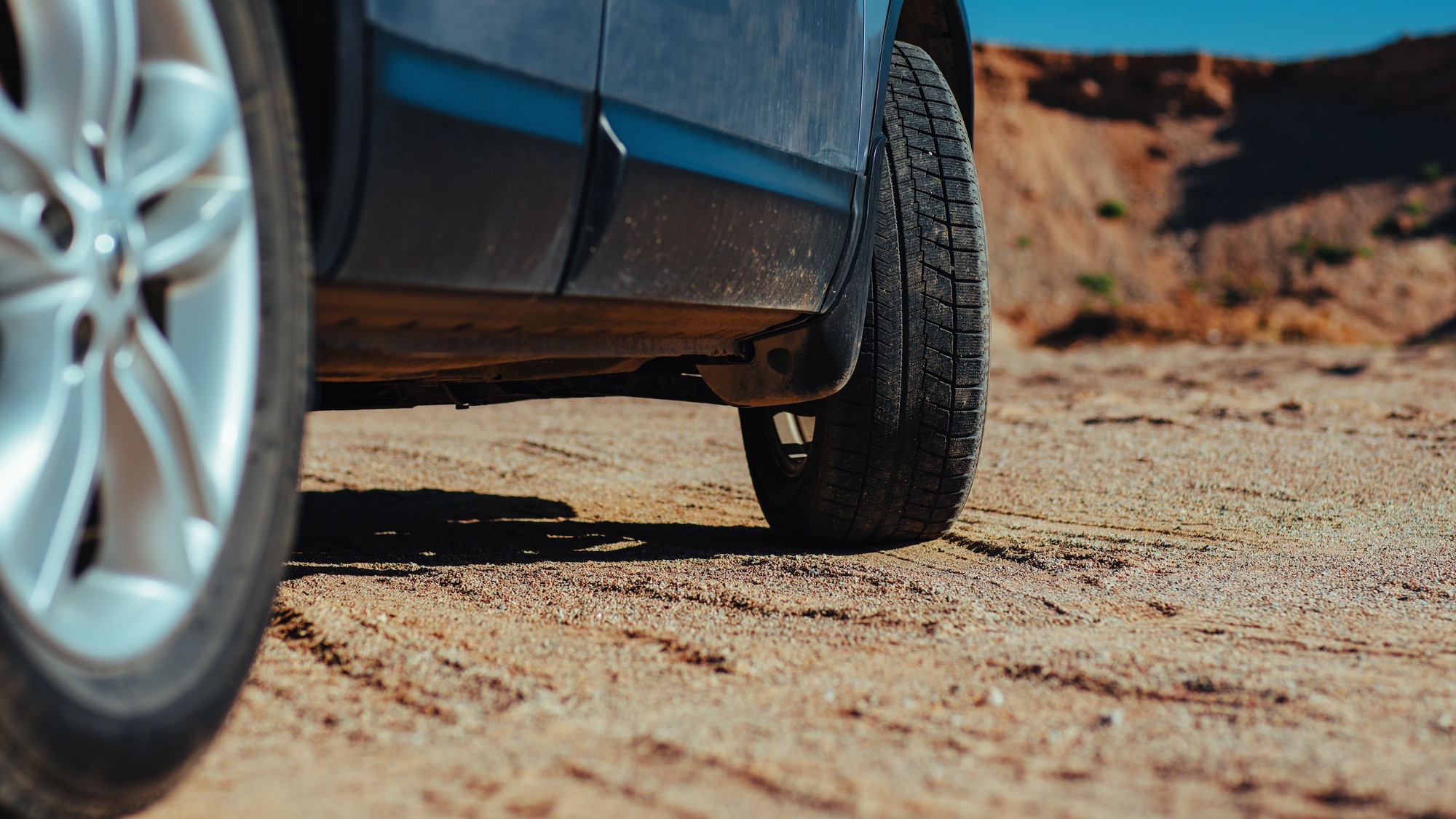 Car offroad drive in sand quarry in summer
