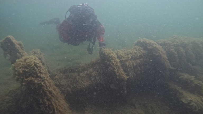 Diver investigating shipwreck underwater