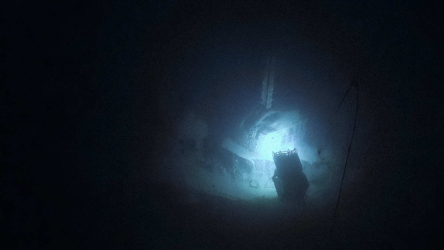 ROV light illuminating underwater shipwreck