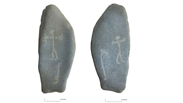 A stone rock with etched art. On one side, a human figure and probably a dog are pecked in with dots. A bow and arrow are carved above the hand on the right side. On the other side, there is a human figure, an unknown figure, and a large boat.
