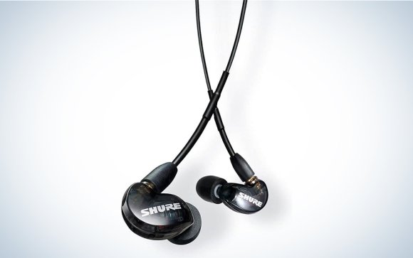 Black Shure SE215 Pro in-ear monitors on a grey gradient
