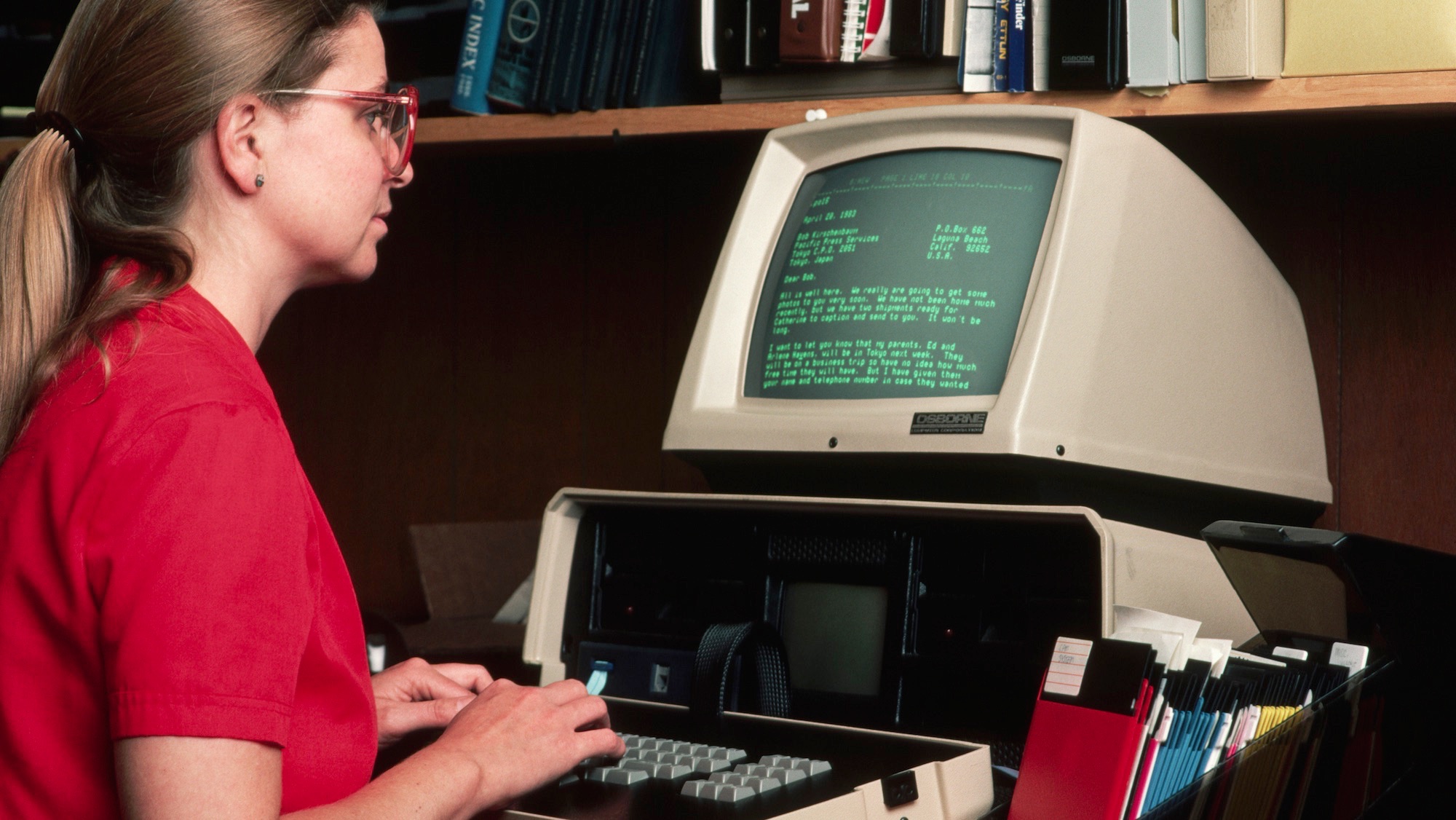 An office worker uses the first Osborne computer.