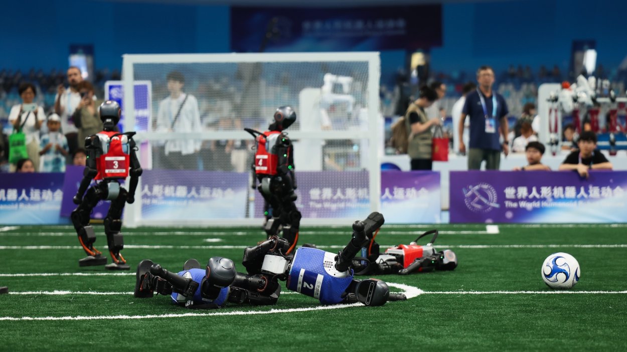Humanoid robots compete in the 5v5 soccer during the day one of 2025 World Humanoid Robot Games at National Speed Skating Oval on August 15, 2025 in Beijing, China.