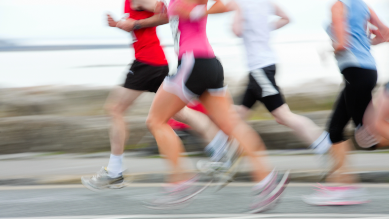 blurred image of a group of runners running