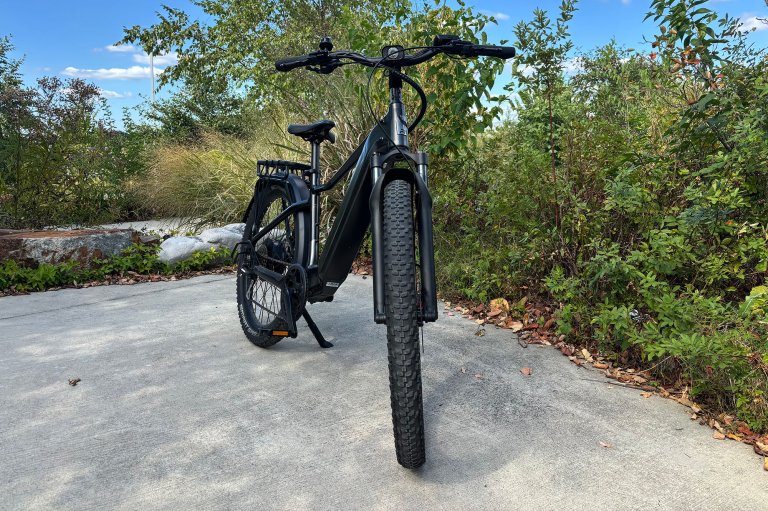A grey Ride1Up Vorsa ebike SUV from the front against a green foliage background