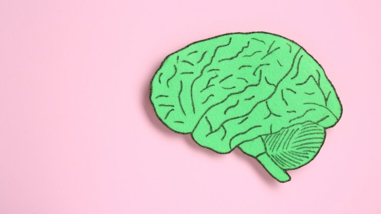 Paper cutout of human brain on pink background, top view. Space for text