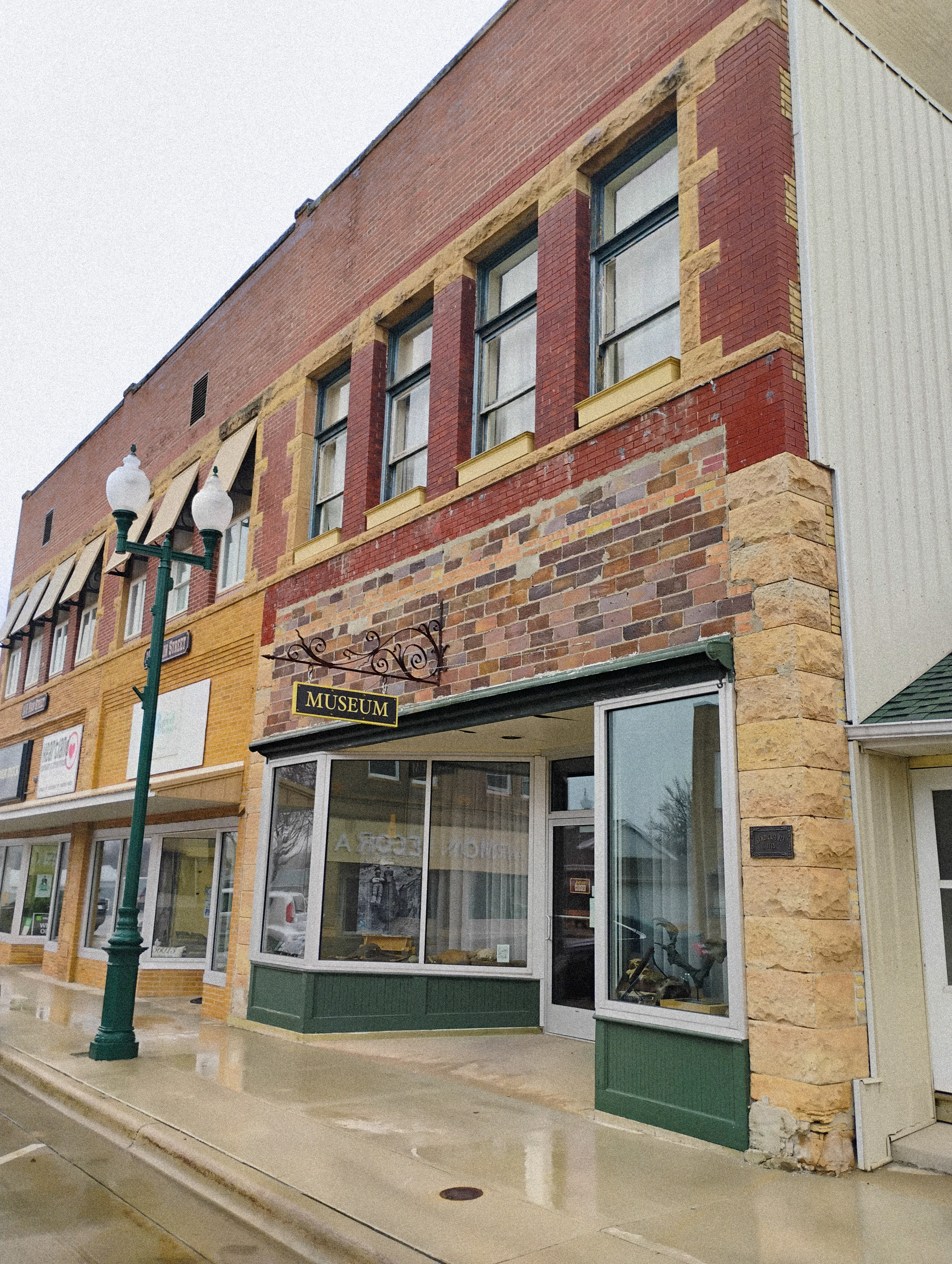 a storefront on a main street with a sign that reads "musuem"