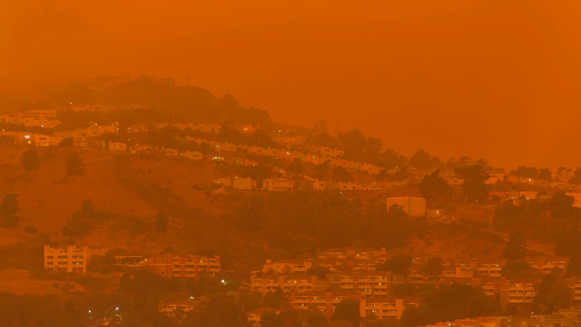 Thick orange haze above San Francisco on September 9 2020 from record wildfires in Californa, daytime view of ash and smoke floating over the Bay Area