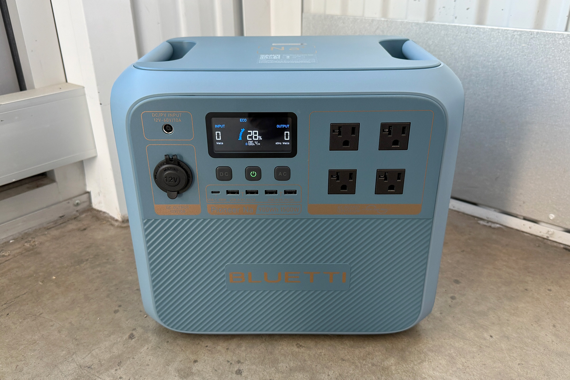 Blue Bluetti Pioneer Na portable power station shown in a storage unit from the front