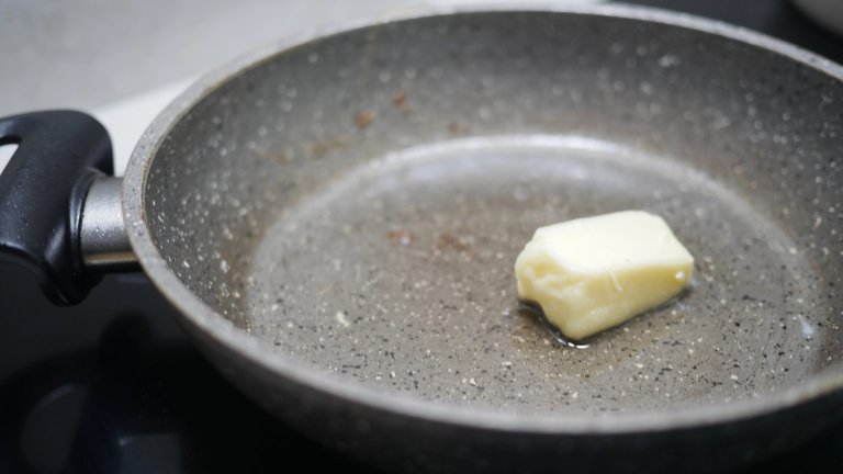 Butter is slowly melting in a frying pan