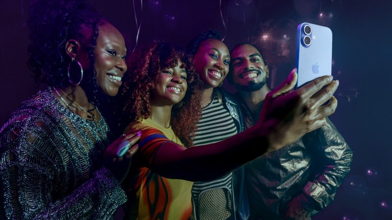 a group of friends posing for a selfie with an iphone