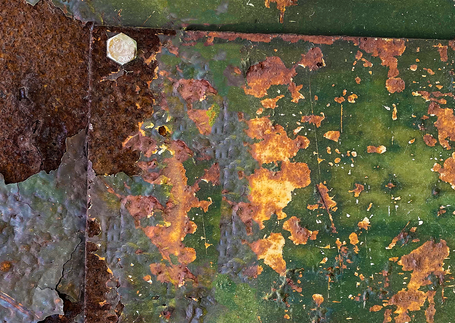 tarnished metal with green, orange, and brown splotches