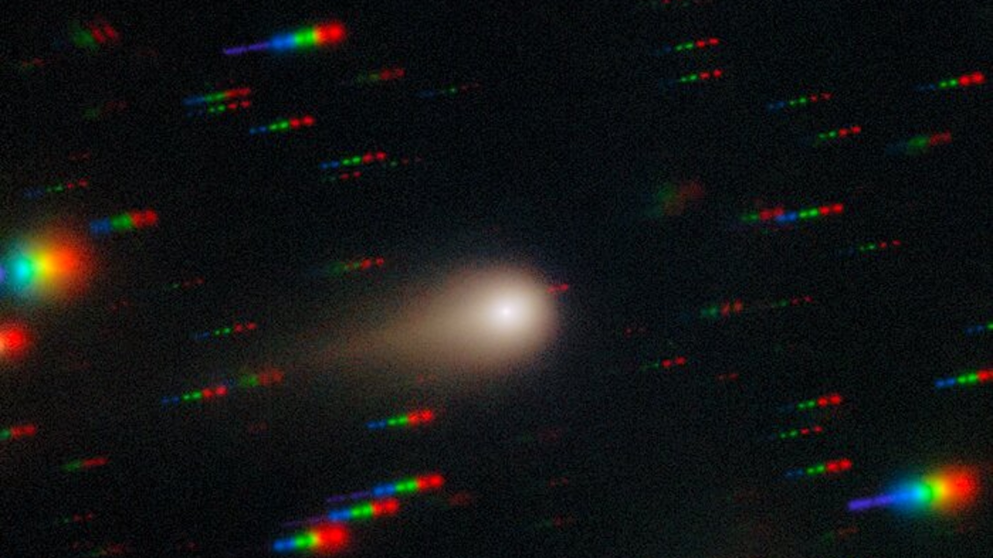 Comet 3I/ATLAS streaks across a dense star field in this image captured by the Gemini Multi-Object Spectrograph (GMOS) on Gemini South at Cerro Pachón in Chile, one half of the International Gemini Observatory, partly funded by the U.S. National Science Foundation (NSF) and operated by NSF NOIRLab. This image is composed of exposures taken through four filters — red, green, blue and ultraviolet. As exposures are taken, the comet remains fixed in the center of the telescope’s field of view. However, the positions of the background stars change relative to the comet, causing them to appear as colorful streaks in the final image. See a version of the image where the stars have been “frozen” here. These observations of Comet 3I/ATLAS were conducted during a Shadow the Scientists program hosted by NSF NOIRLab. A full recording of the session can be found here.