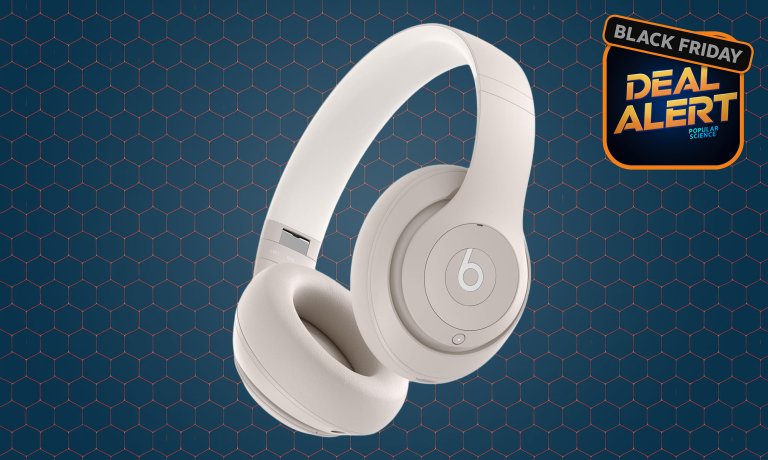 Sandstone Beats Studio Pro headphones on a dark blue Amazon Black Friday background