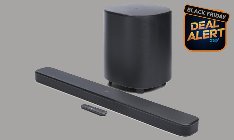 A JBL 500MK2 soundbar, wireless subwoofer, and remote on a grey Amazon Prime Black Friday background