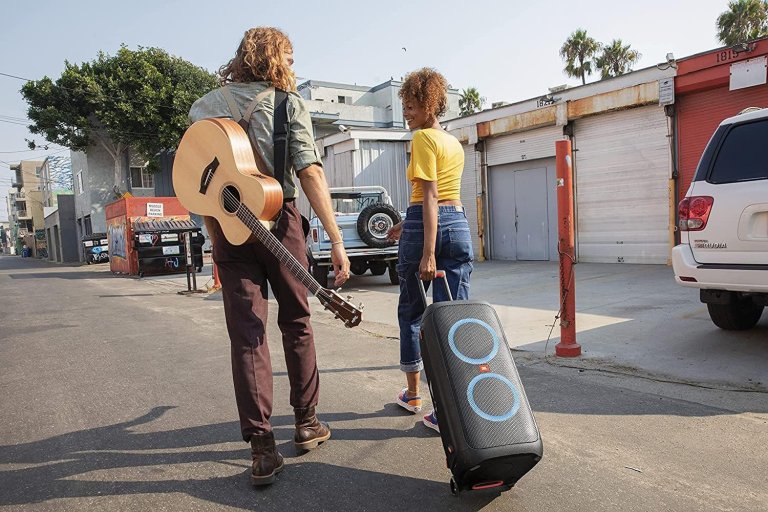 A woman and a man walking in LA with a JBL PartyBox 310 speaker