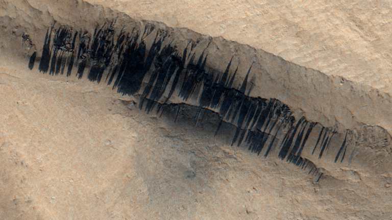 Dark lines of discolored dust on slopes of Martian mountain