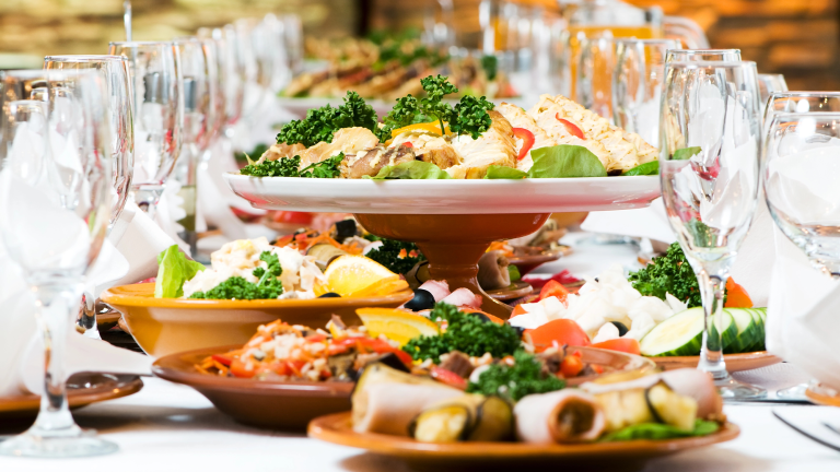 a catering table set up with large plates of food