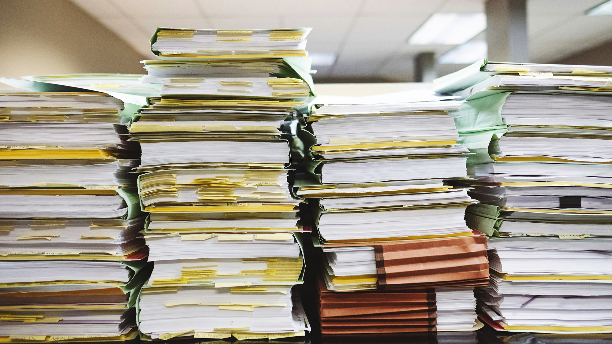 a desk with a pile of papers