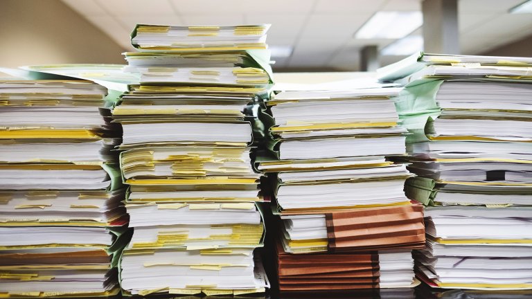 a desk with a pile of papers
