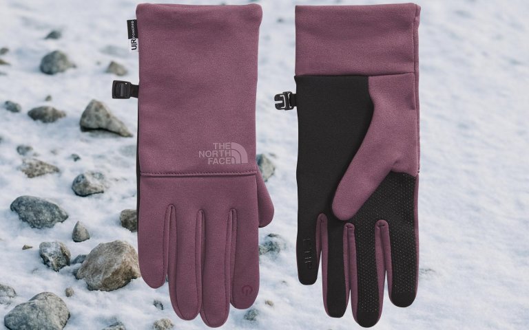 The North Face gloves on sale at REI on a snowy rocky background