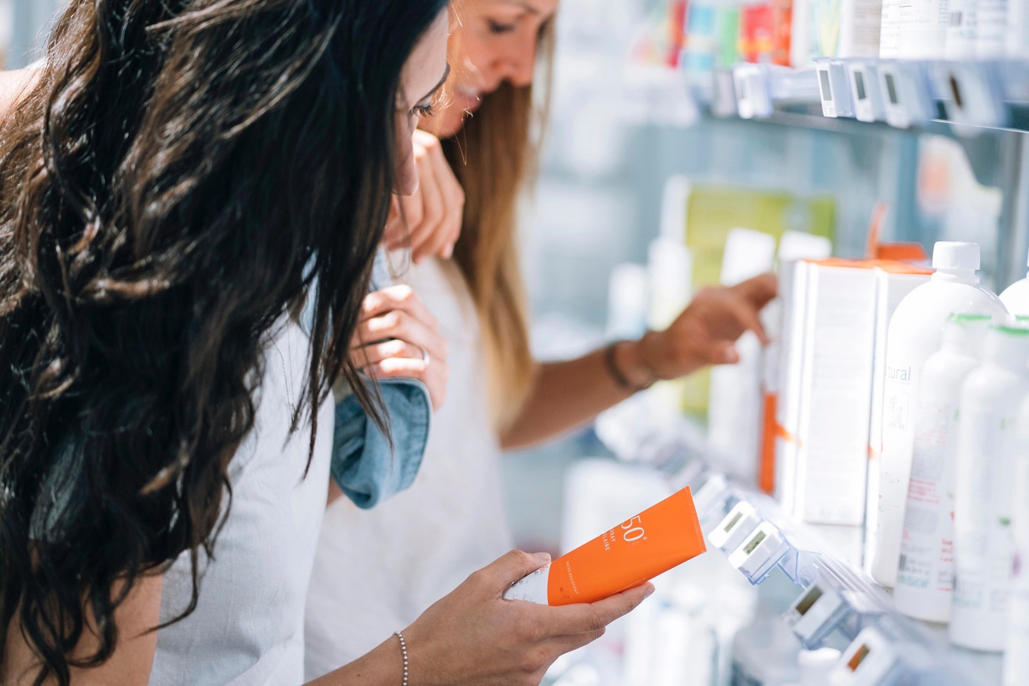 Two women stocking up on sunscreen with their remaining 2025 FSA funds