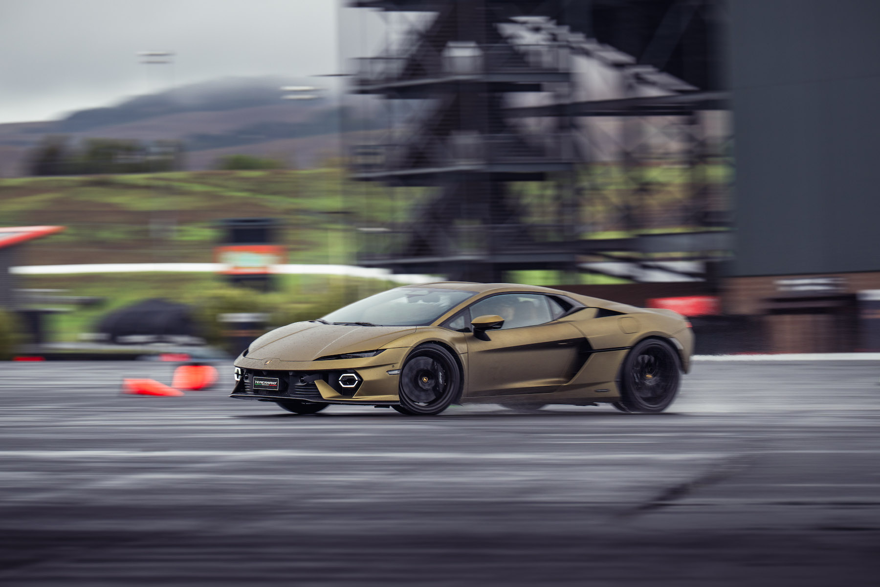 a Lamborghini on a track, blurry background